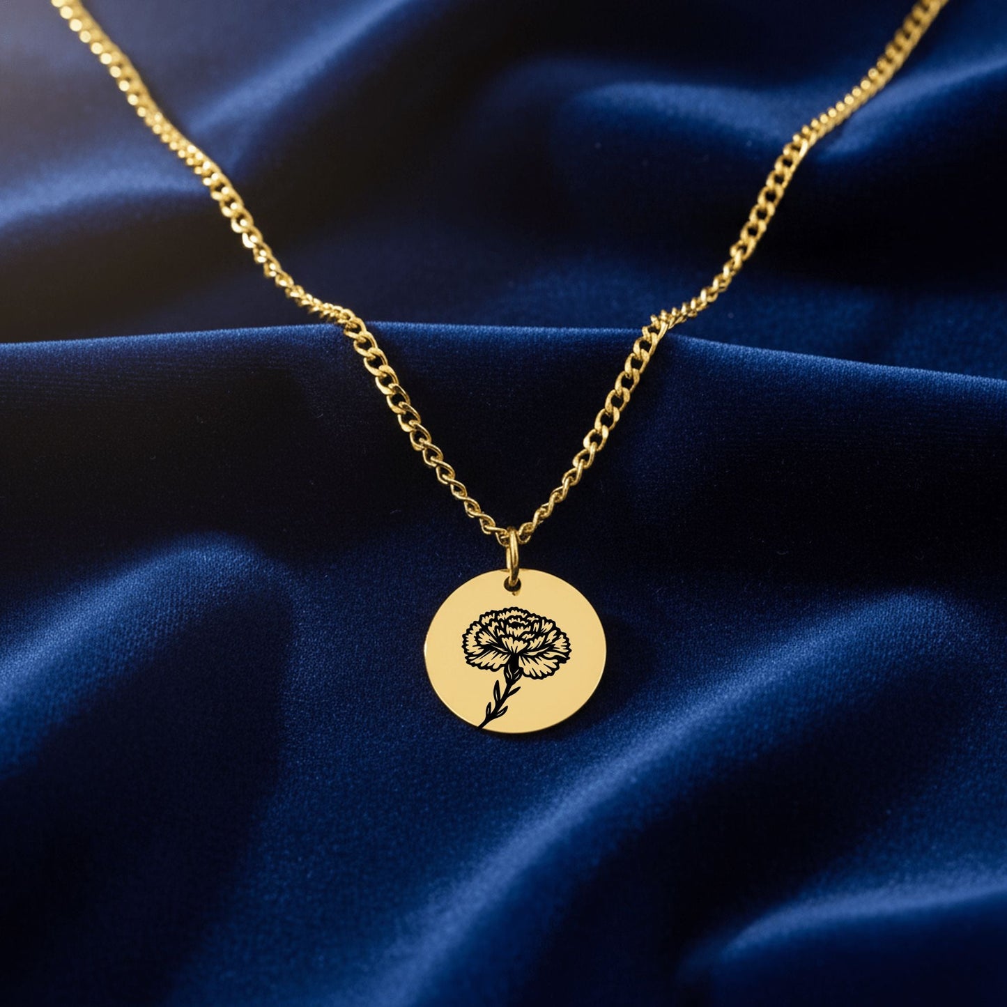 Gold necklace with a round pendant on a blue fabric background